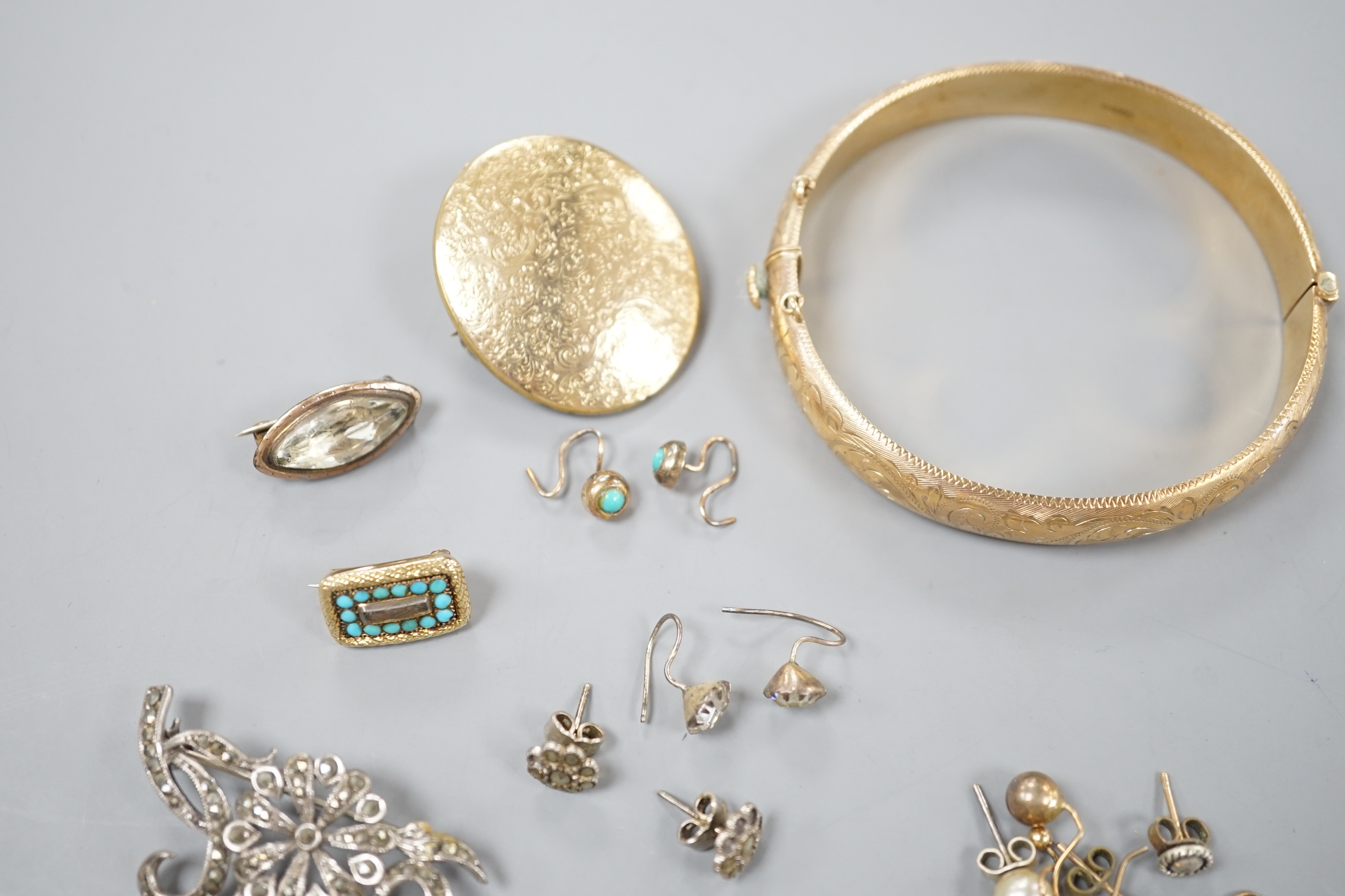 A 9ct gold hinged bangle, 17.4 grams, an engraved yellow metal locket, a 9ct and gem set bar brooch, gross 3.3 grams, a Victorian yellow metal and turquoise set small mourning brooch, one other brooch, assorted earrings